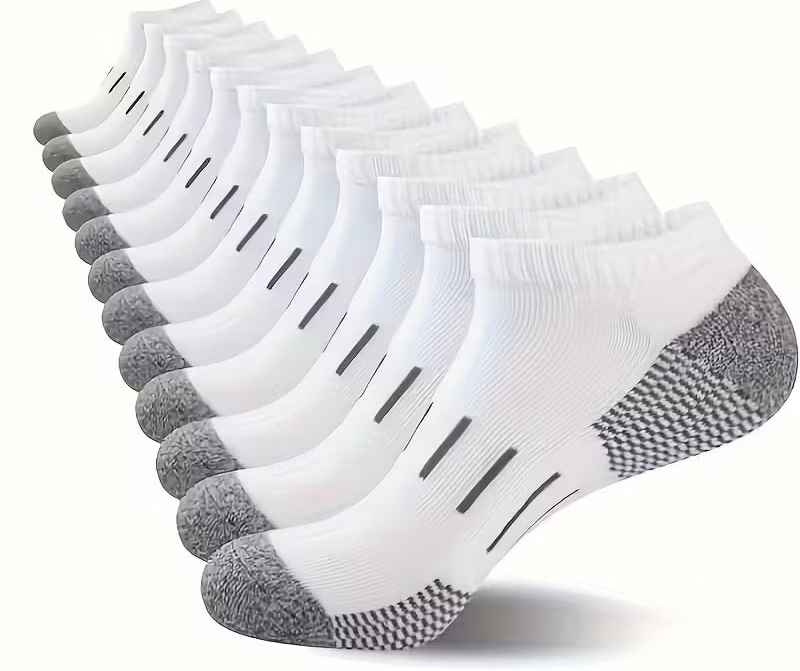 Twelve pairs of low-cut white athletic socks with gray heels, toes, and textured grip soles, arranged in a fan shape on a white background with '12 pairs' text at the top.